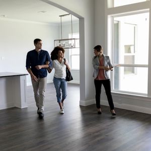 A realtor walking a couple through a house