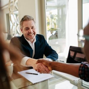 A realtor shaking hands with a client